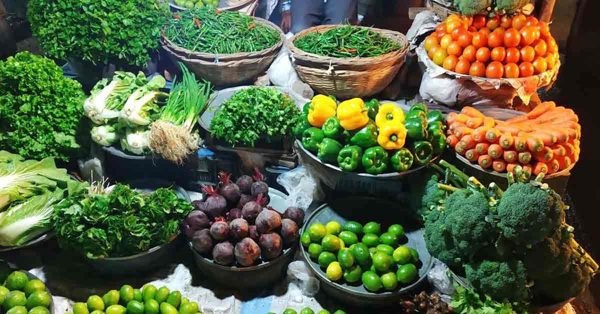 Assorted fresh vegetables including tomatoes, carrots, cucumbers, and bell peppers