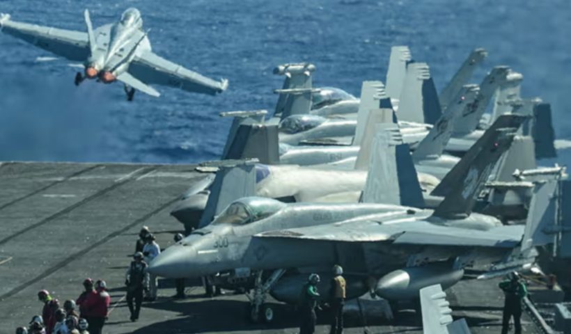 An F/A-18 fighter jet takes off from a US aircraft carrier